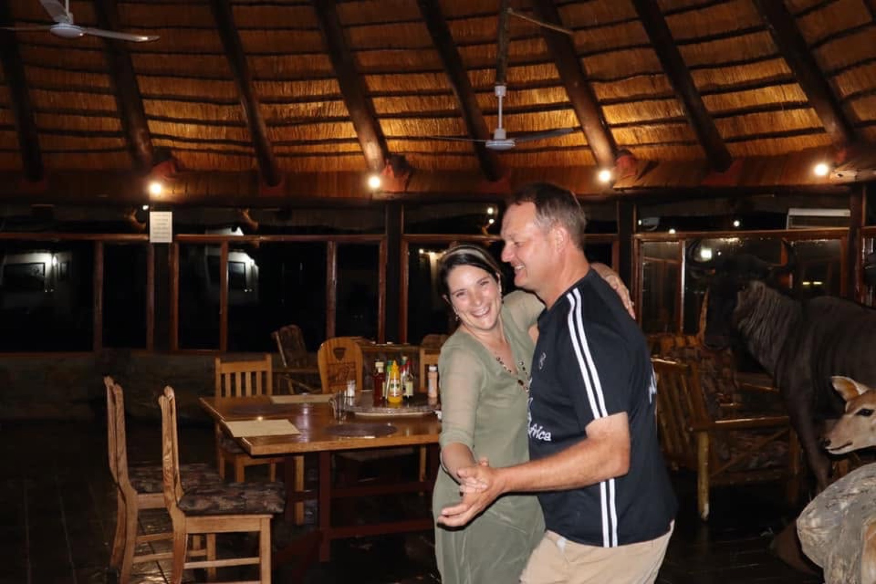 Izak and Linky Kirsten dancing in a thatch lodge dining room