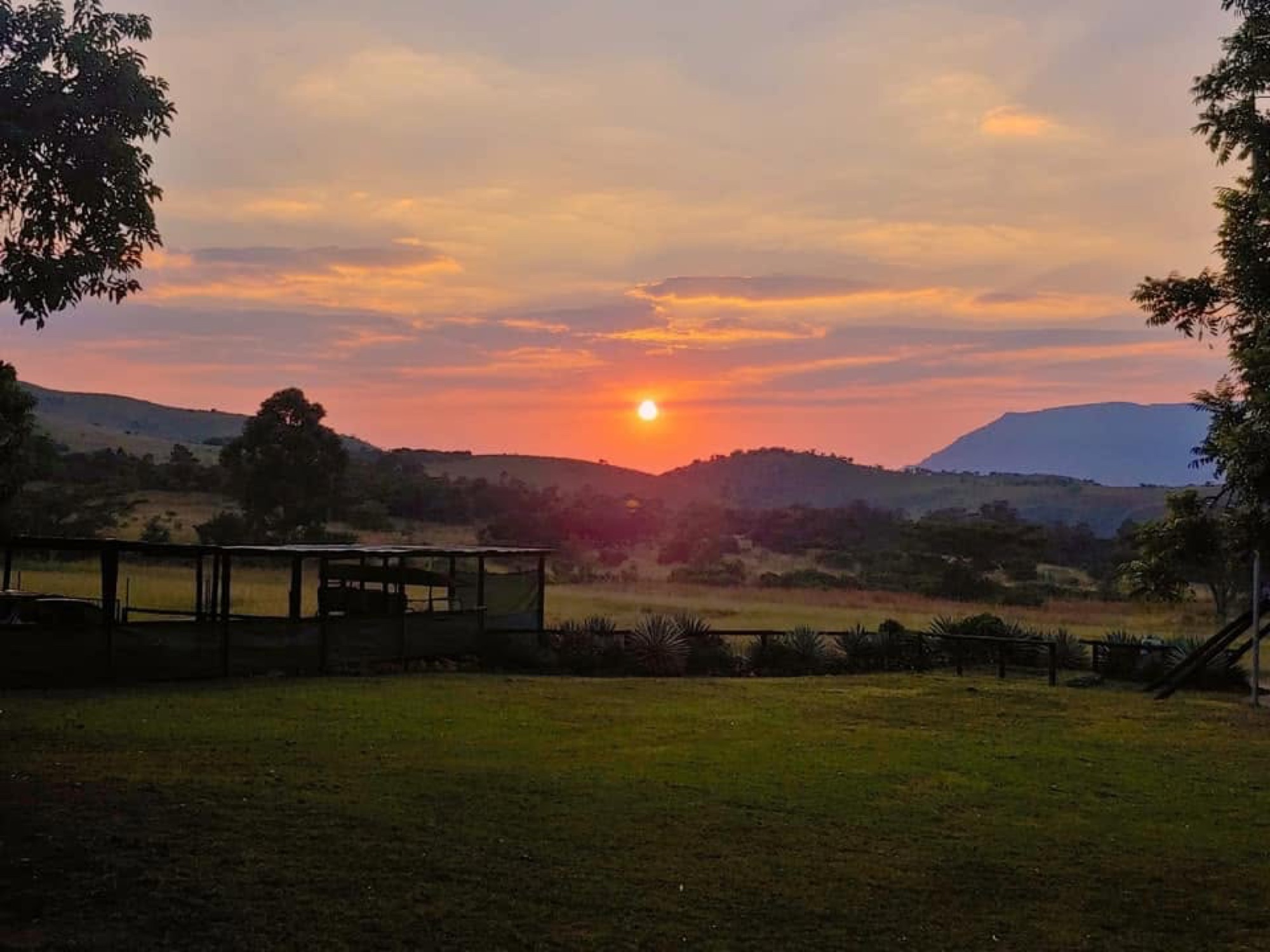 Sunset over the hills from a lodge lawn